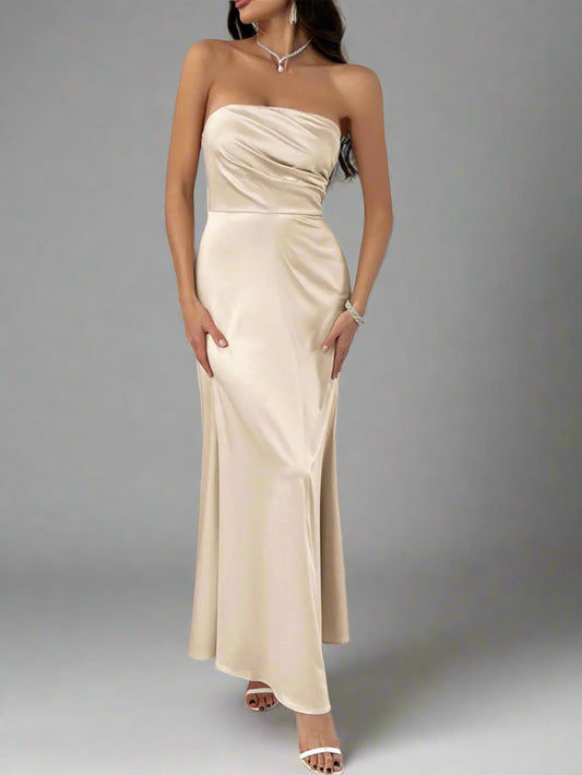 A woman is wearing Devine Ruched Tube Maxi Dress