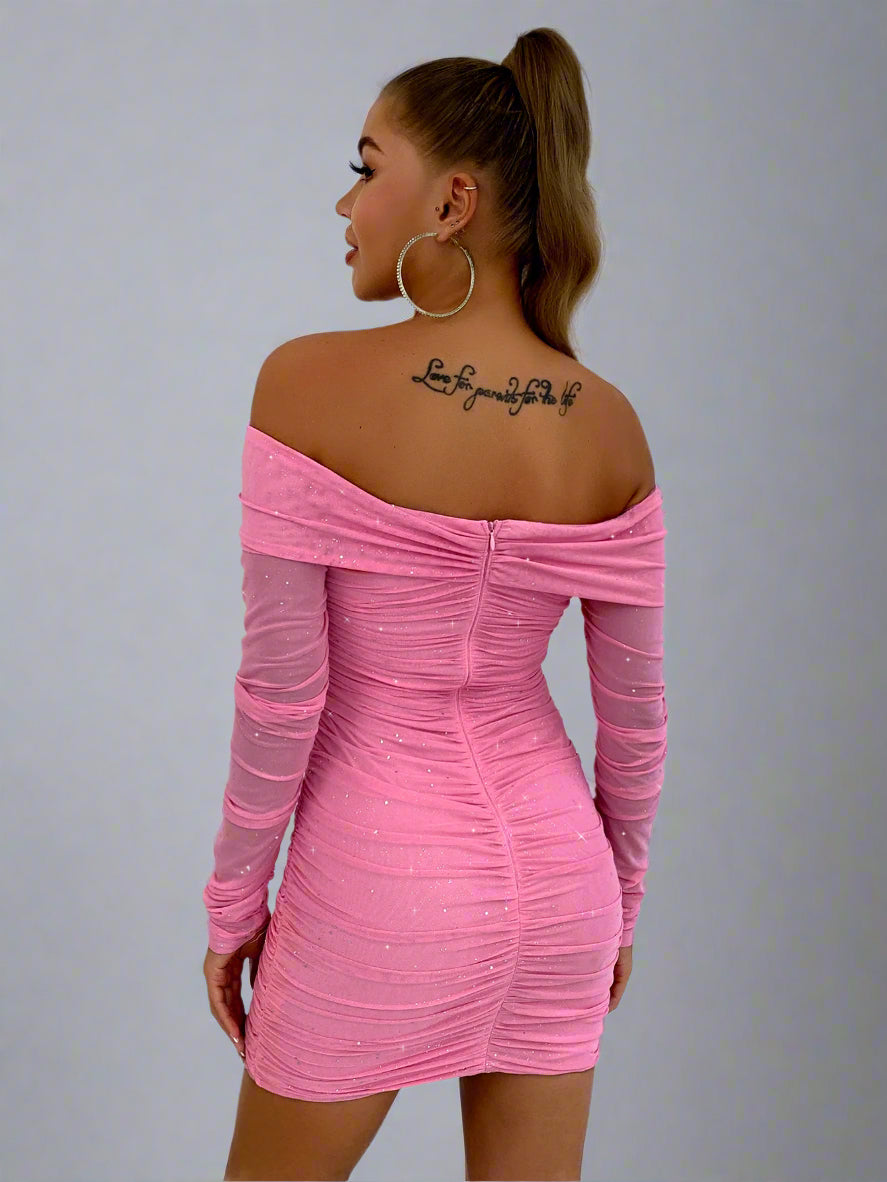 A woman is wearing The Luxe Lure Glitter Long Sleeve Bodycon Dress Pink Full Back