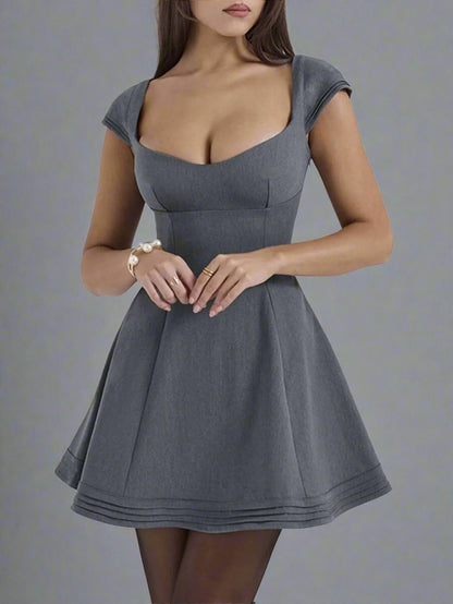 A woman is wearing Devine Lace-Up Sweetheart Neck Cap Sleeve Mini Dress
