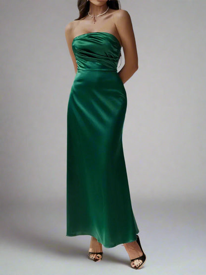 A woman is wearing Devine Ruched Tube Maxi Dress