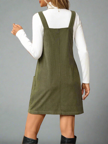 a woman is wearing Texture Sleeveless Mini Dress with Pockets
