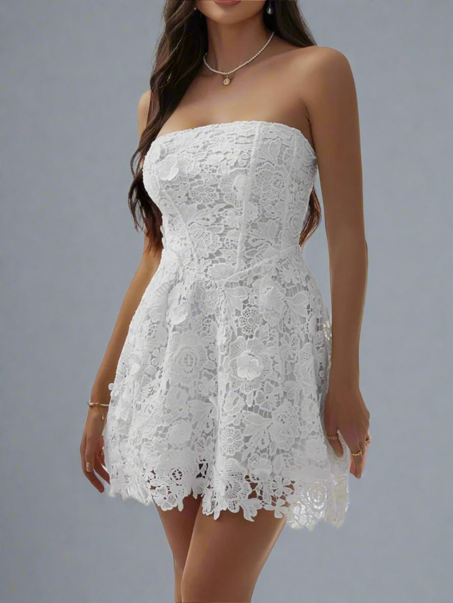 A woman is wearing The Lacey Mini Dress in White
