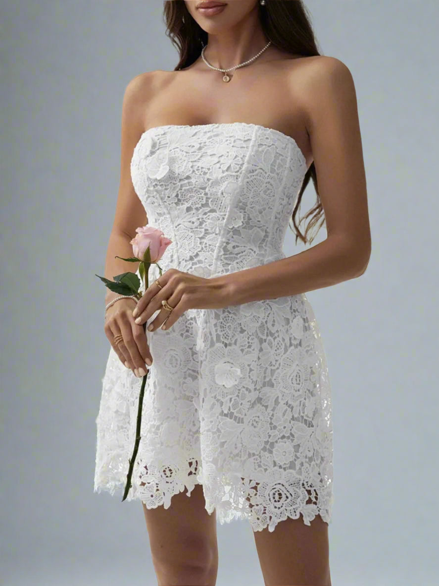 A woman is wearing The Lacey Mini Dress in White
