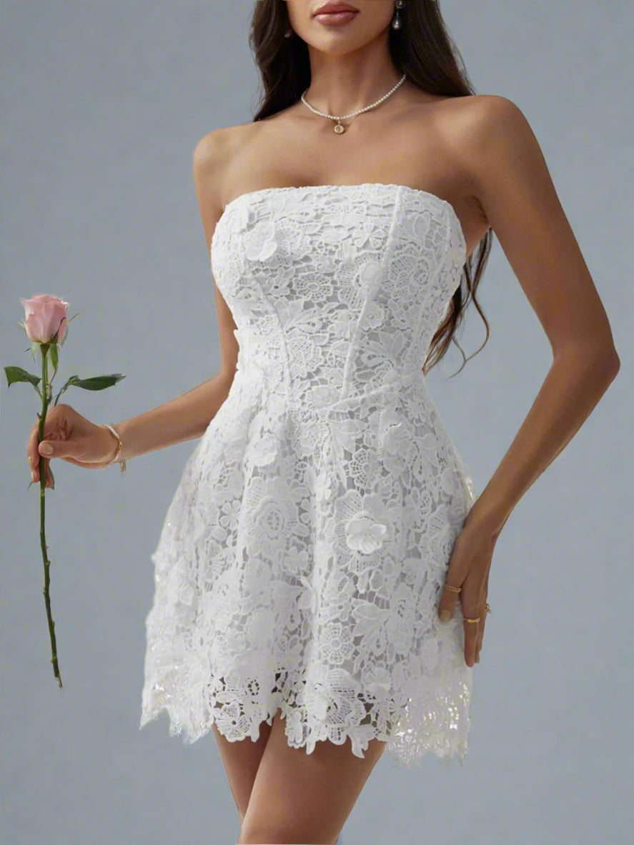 A woman is wearing The Lacey Mini Dress in White
