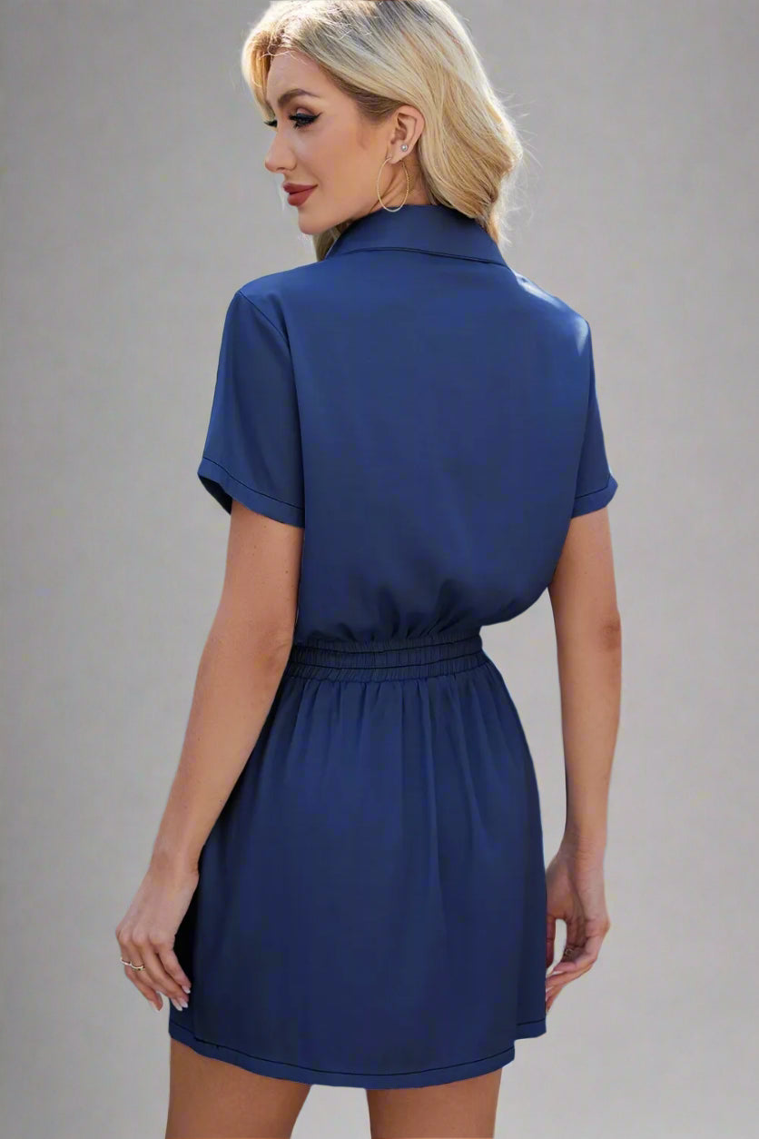 A woman is wearing The Midnight Wrangler Drawstring Dark Denim Dress 
